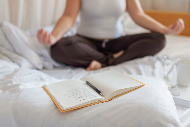 Person meditating in serene setting for wellness